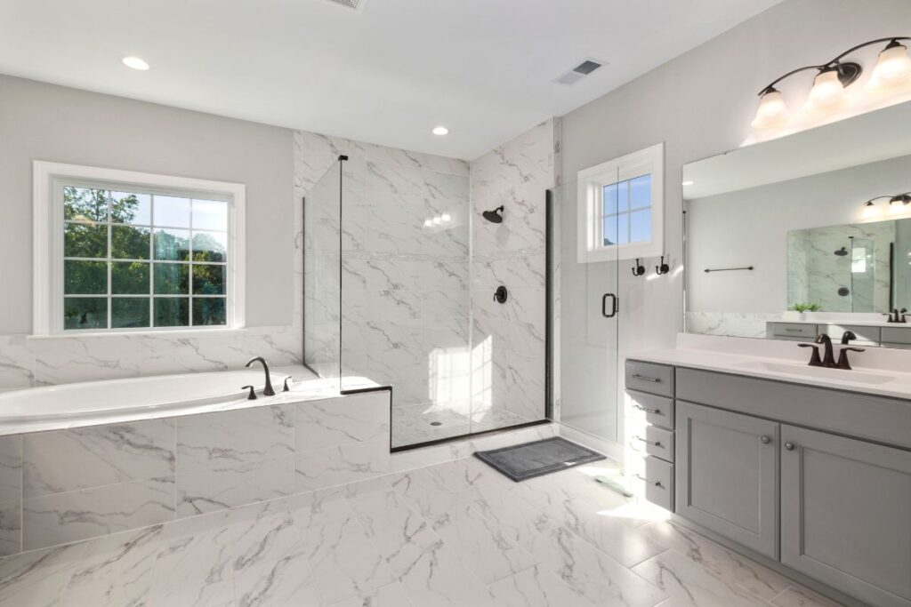 Renovated bathroom with freestanding bath, walk-in shower and double vanity